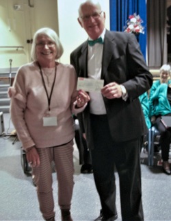 Richard Hartley, Chairman of The Malvern Singers presents a cheque for £750 to a representative of Malvern Special Families